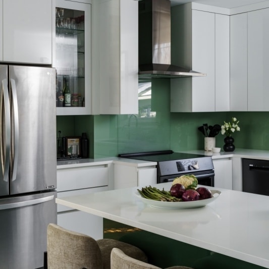 Fridge and range in contemporary green & white kitchen