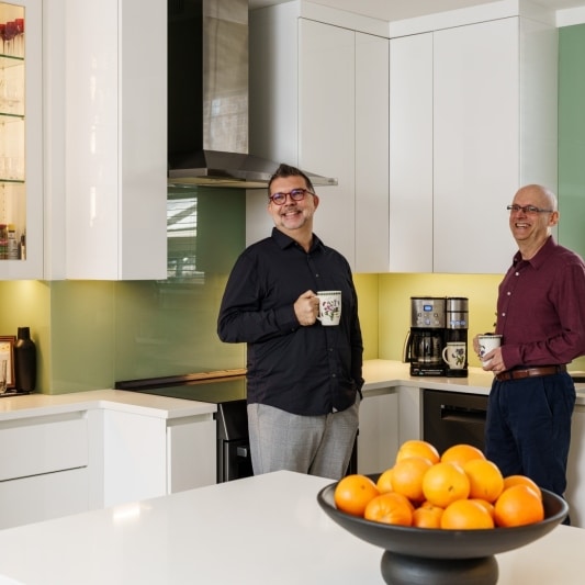 Couple having coffee in contemporary kitchen