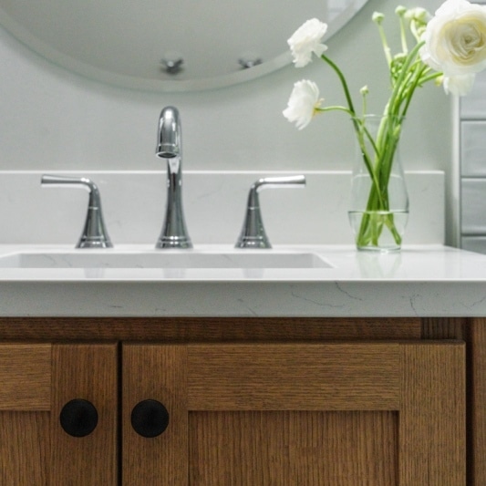 Kansas City Bathroom remodel with single white oak vanity and subway format tile