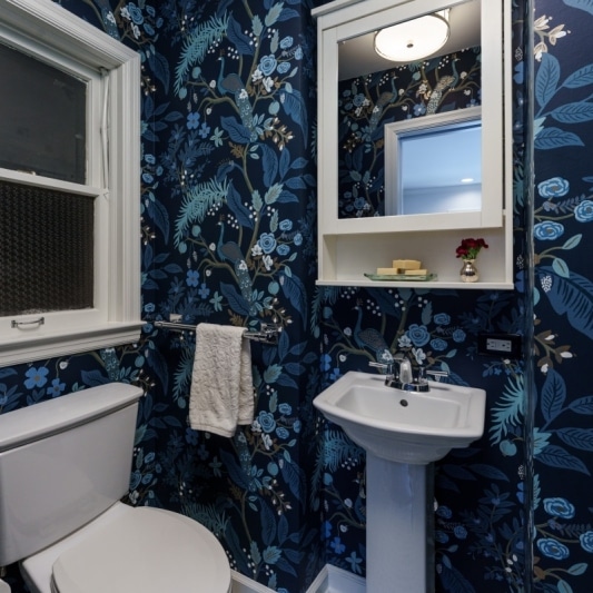 Powder bath with blue pattern wallpaper