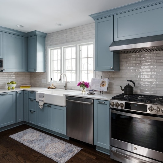 Kitchen with light blue cabinets and white counters