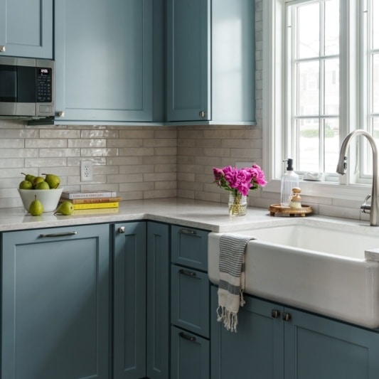 Kitchen with light blue cabinets and farmhouse sink