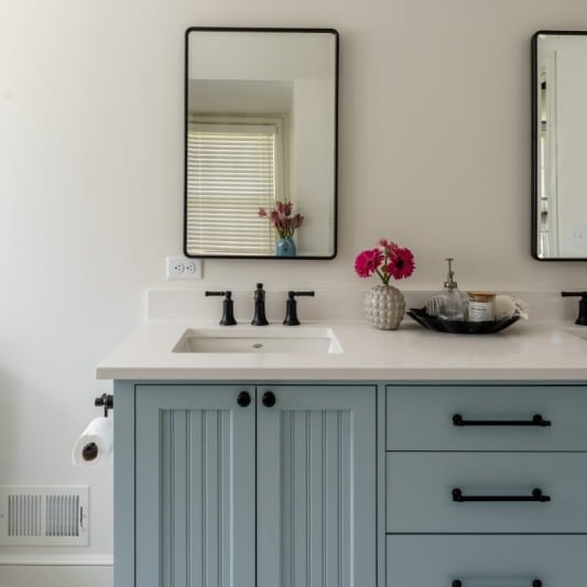 light blue vanity and bright white bathroom