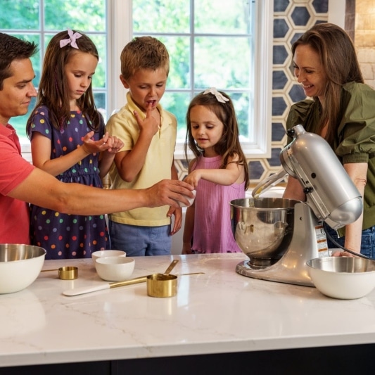 family baking cookies in new kitchen