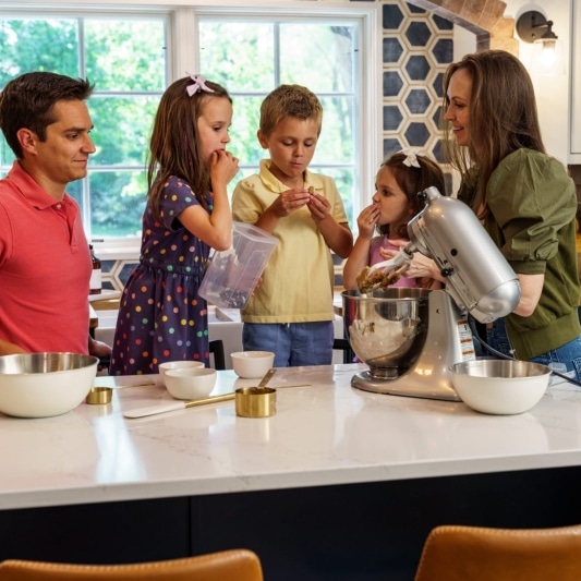 family baking cookies in new kitchen