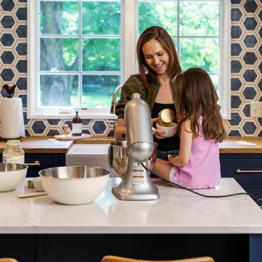 family baking cookies in new kitchen