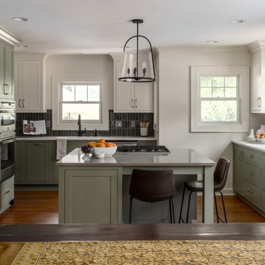 transitional kitchen remodel with sage green cabintry and white upper cabinets for a modern but timeless feel
