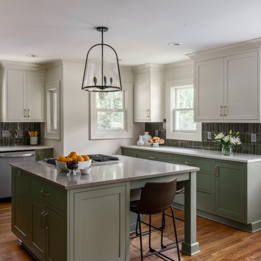 transitional kitchen remodel with sage green cabintry and white upper cabinets for a modern but timeless feel