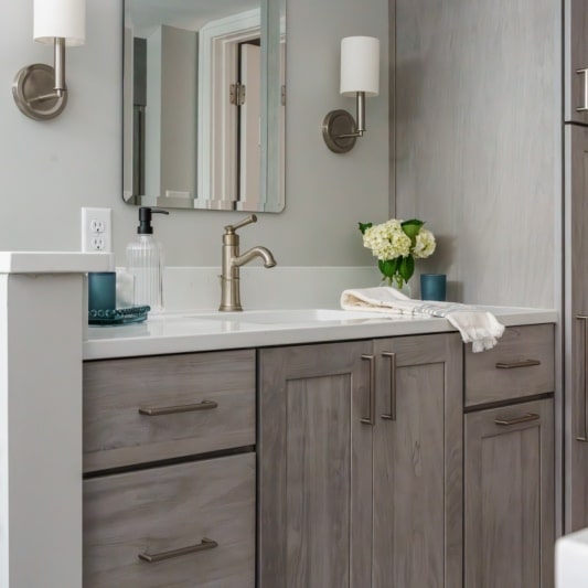 grey stain on white oak primary bathroom cabinetry at vanity