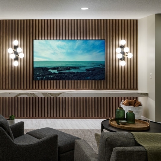 tv wall and sitting area in sleek basement remodel