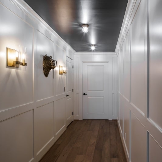 Luxury basement remodel paneled hallway