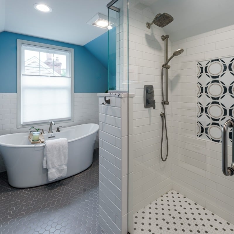 cape cod bathroom remodel with blue accents, large soaking tub, walk-in shower and blue vanity with cambria quartz counters