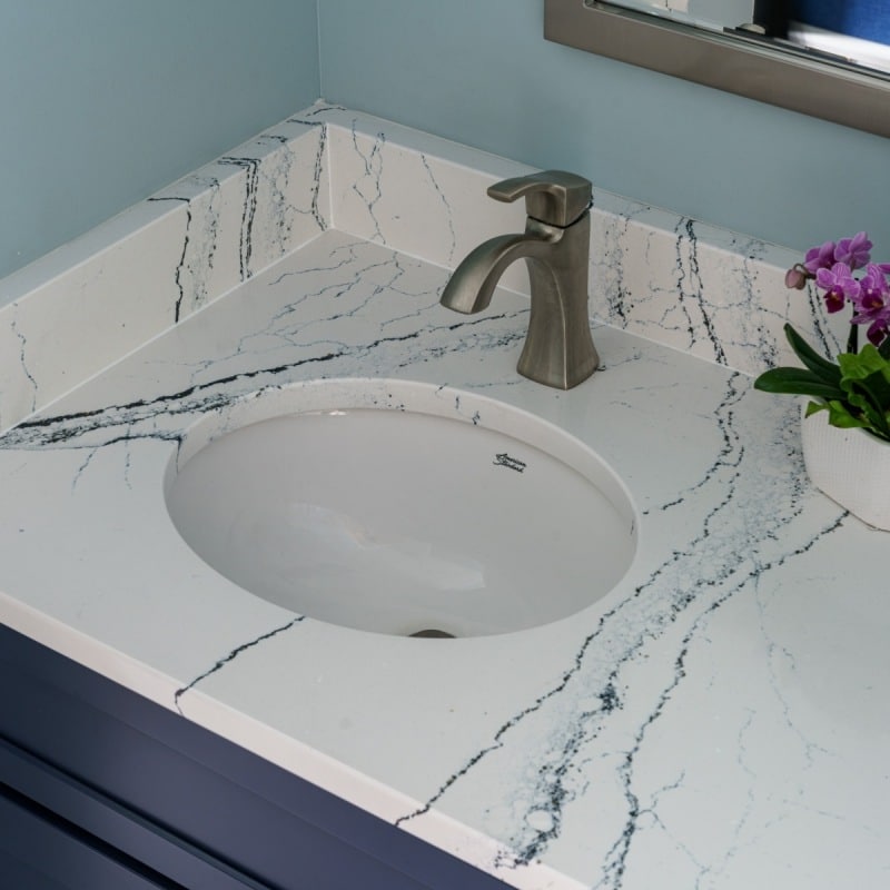 cape cod bathroom remodel with blue accents, large soaking tub, walk-in shower and blue vanity with cambria quartz counters