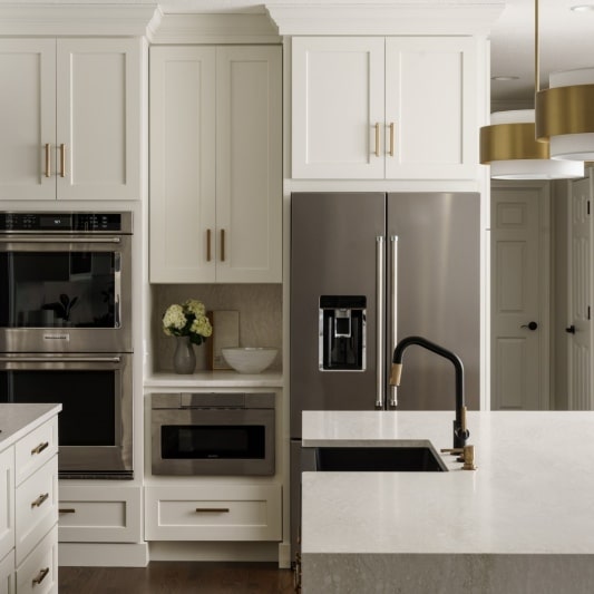 modern sleek glam main floor remodel with black and white details and gold accents and white oak island
