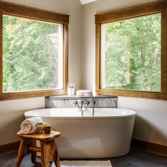 corner windows framing bathtub in primary bath