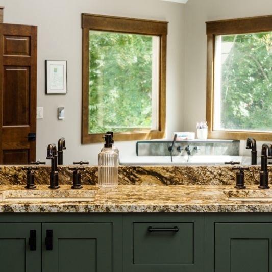 green primary bathroom cabinetry
