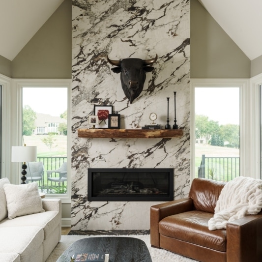 modern dramatic main floor remodel with full slabs of porcelain on the fireplace for a sleek look