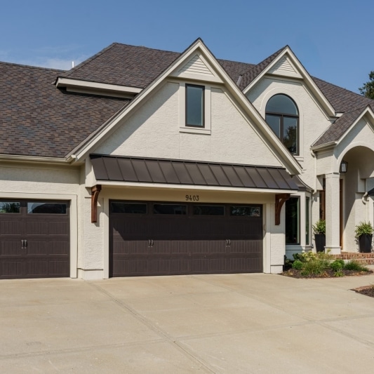 exterior of the whole home remodel with a creamy off white paint and iron ore charcoal accents and black framed windows