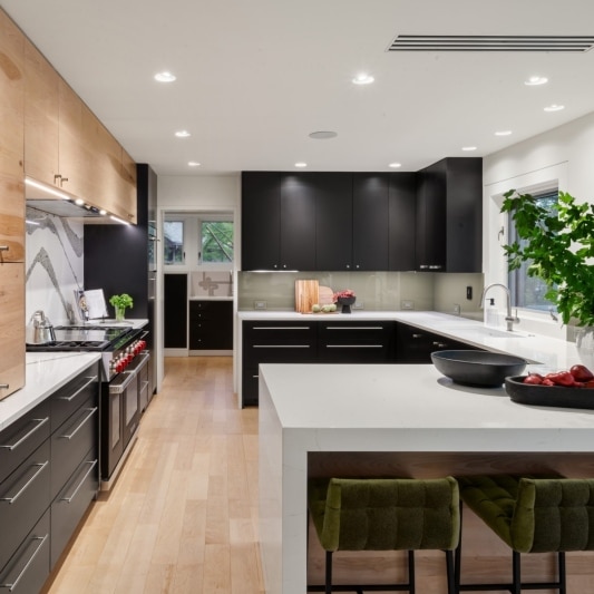 sleek contemporary kitchen remodel with black matte cabinets and white oak and full height backsplash with unique accents