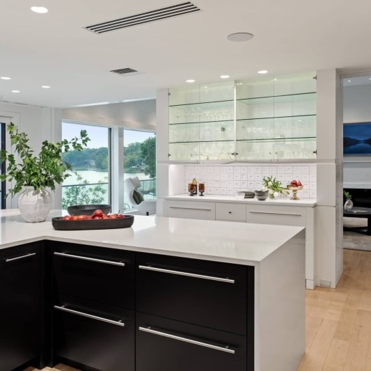 sleek contemporary kitchen remodel with black matte cabinets and white oak and full height backsplash with unique accents