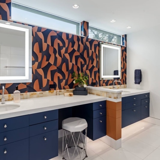 contemporary whole home remodel with retro inspired wallpaper and statement design details in primary suite and bathroom. Navy and burnt orange rust add some personality