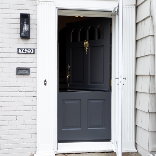 dutch door remodel with dark storm grey paint and brass hardware