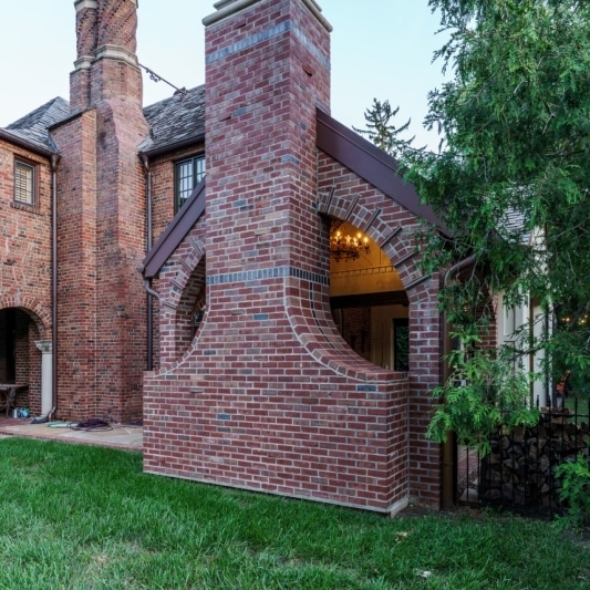 unique brick pattern and curved edges in this covered porch addition