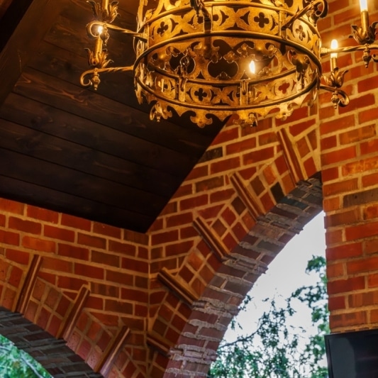 unique brick pattern and curved edges in this covered porch addition