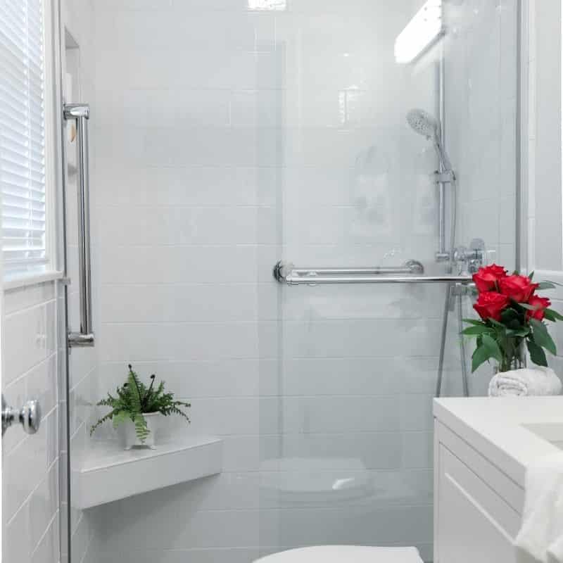 sleek and fresh classic white bathroom remodel with silver hardware and fixtures