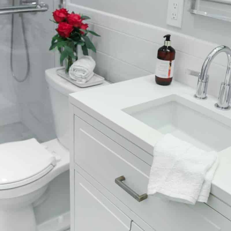 sleek and fresh classic white bathroom remodel with silver hardware and fixtures