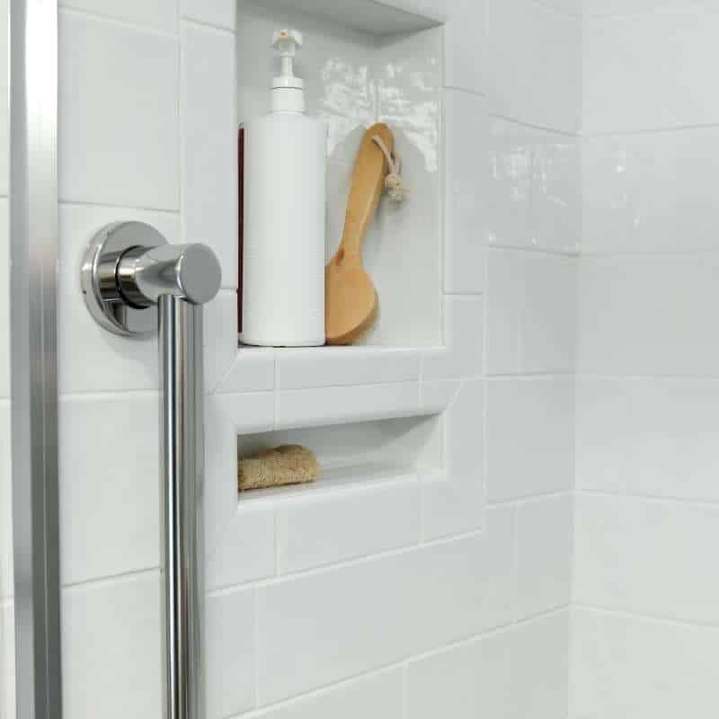 sleek and fresh classic white bathroom remodel with silver hardware and fixtures