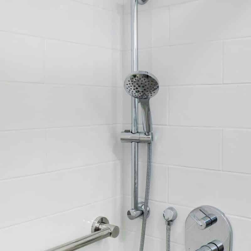 sleek and fresh classic white bathroom remodel with silver hardware and fixtures