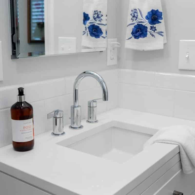 sleek and fresh classic white bathroom remodel with silver hardware and fixtures