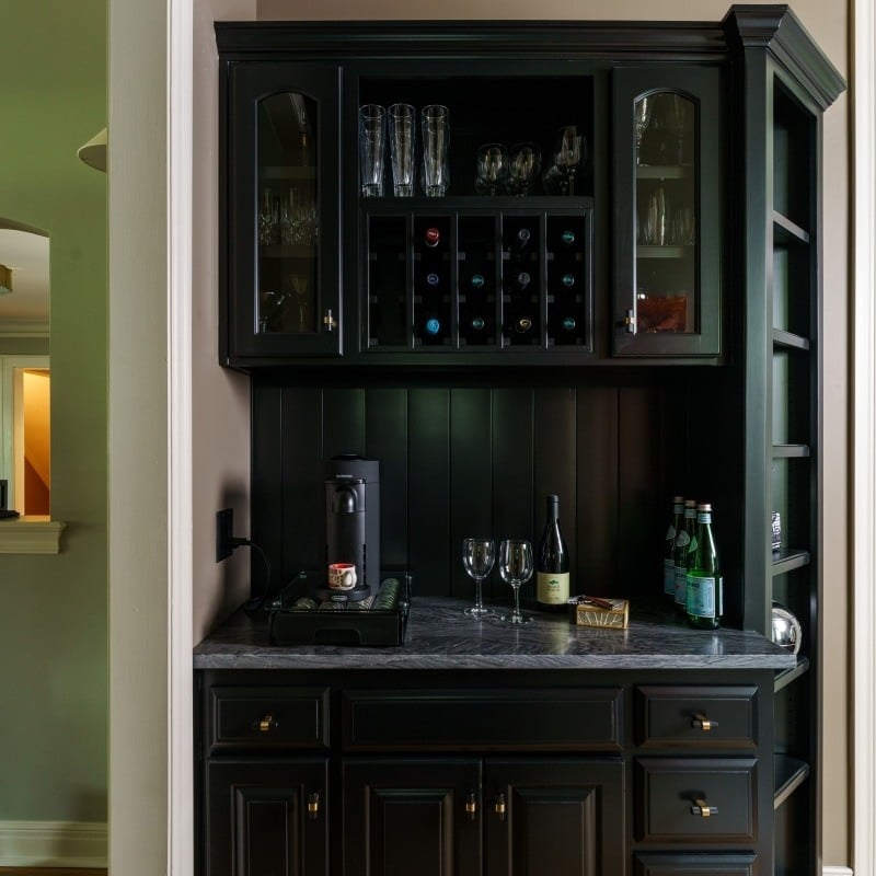 black coffee and wine storage nook in kitchen remodel with dark counter tops and built in shelving