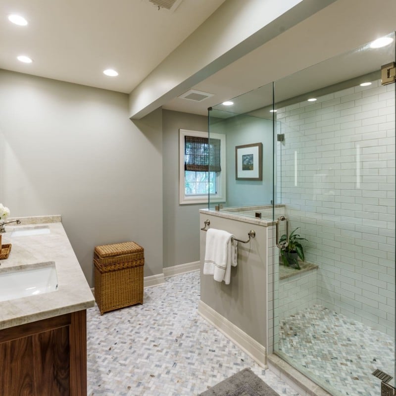 modern spa like bathroom with large walk in shower and warm oak vanity