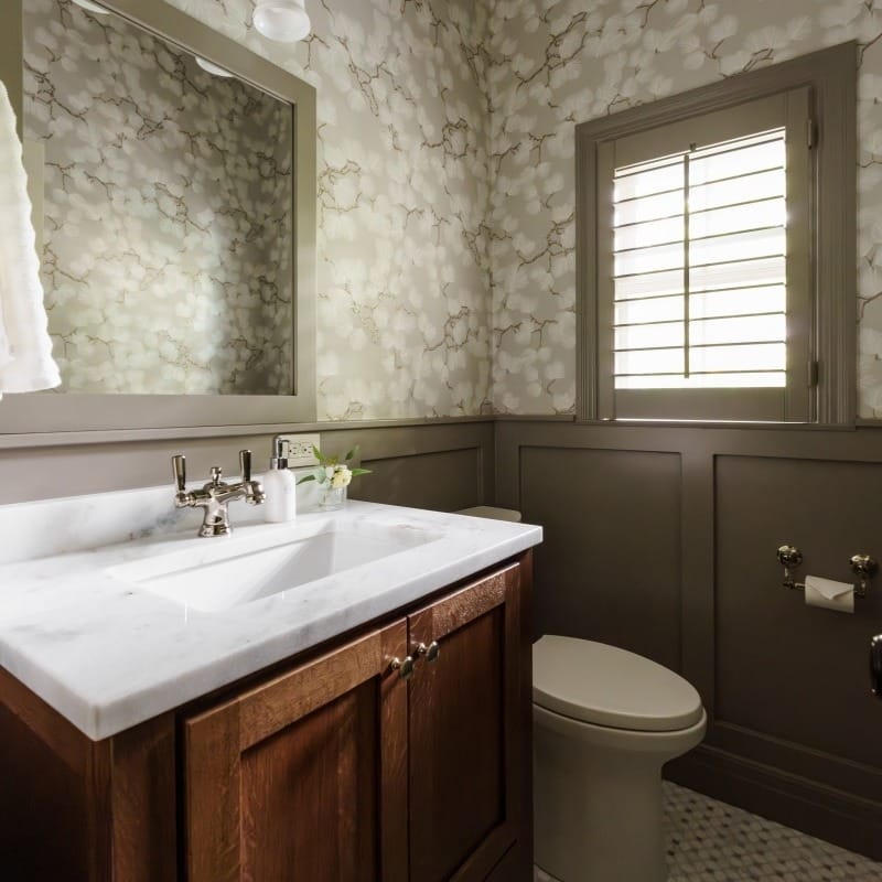 modern spa like bathroom with warm oak vanity and printed wallpaper and color drench