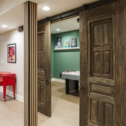 Basement game room with antique barn doors