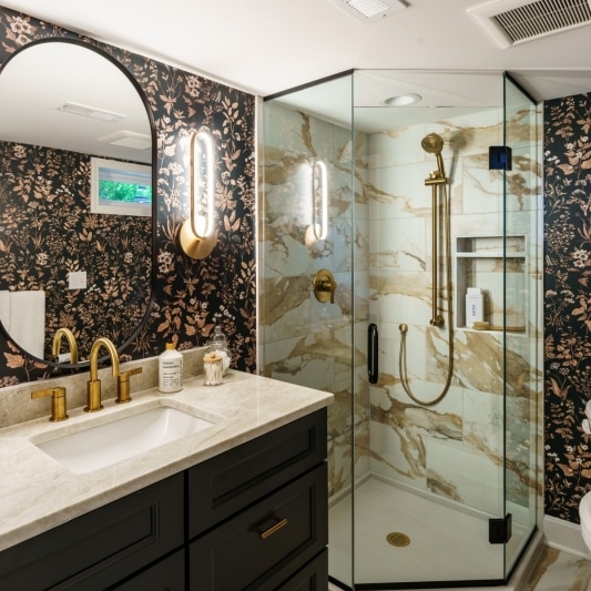 Bathroom with corner tiled shower, dark vanity and floral dark wallpaper