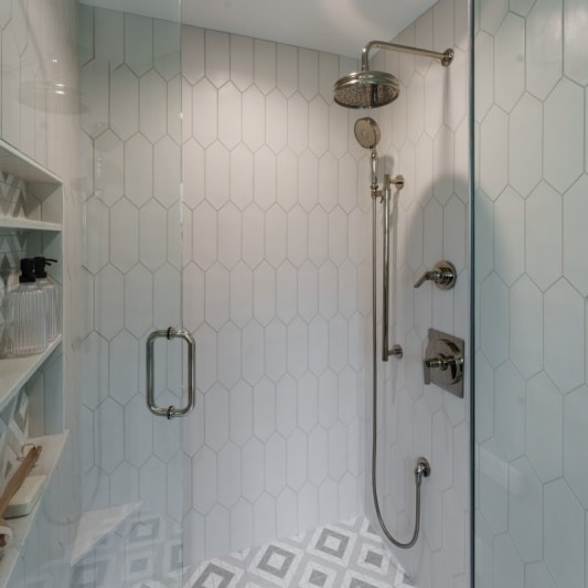 white shower tile and silver hardware