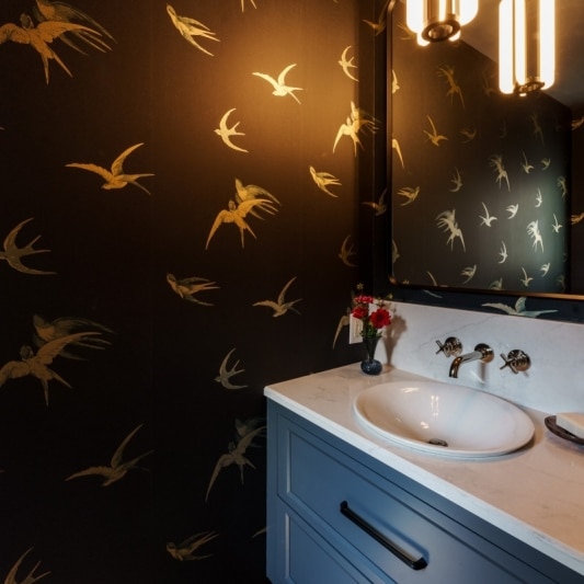 black Schumacher bird wallpaper in statement moody powder bath
