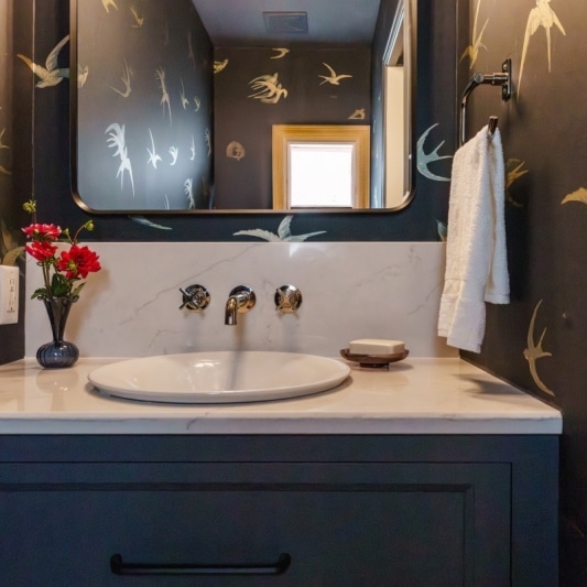 black Schumacher bird wallpaper in statement moody powder bath