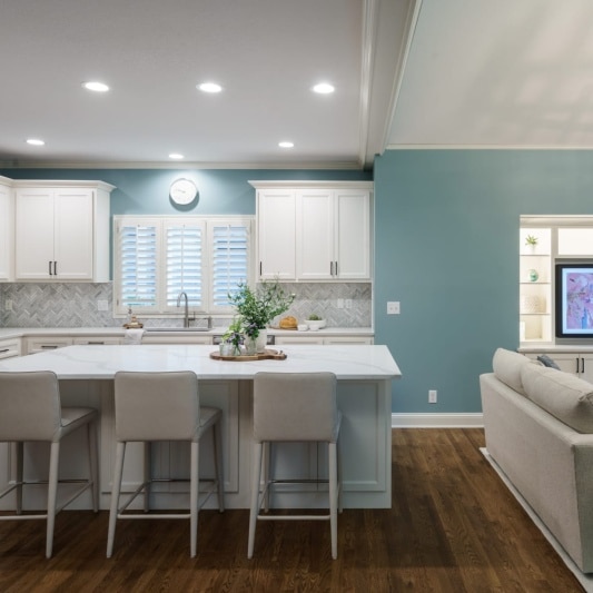White kitchen and living area with blue painted walls