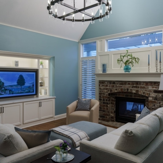 Living room with blue walls and white built-in cabinets