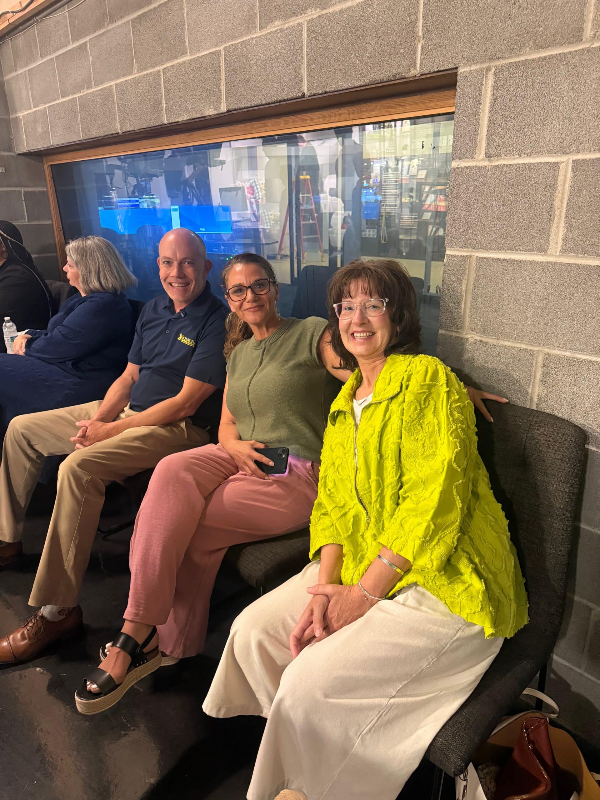 behind the scenes shot of our team and Laurie from PRC sitting back stage before the news segment