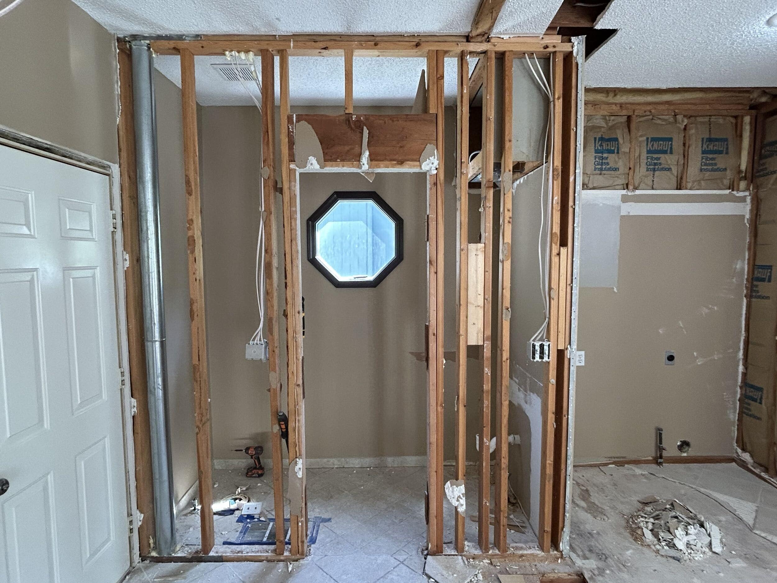 demo of powder bathroom and laundry room area near kitchen.