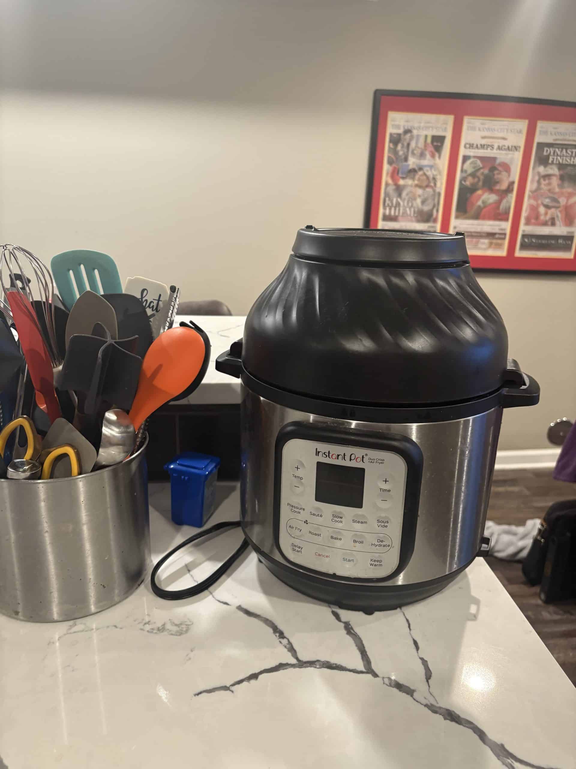 instant pot temporary kitchen during remodel image of an instant pot on the counter with spoons and spatulas on the counter in the basement temporary kitchen during the remodel of the lenexa kitchen