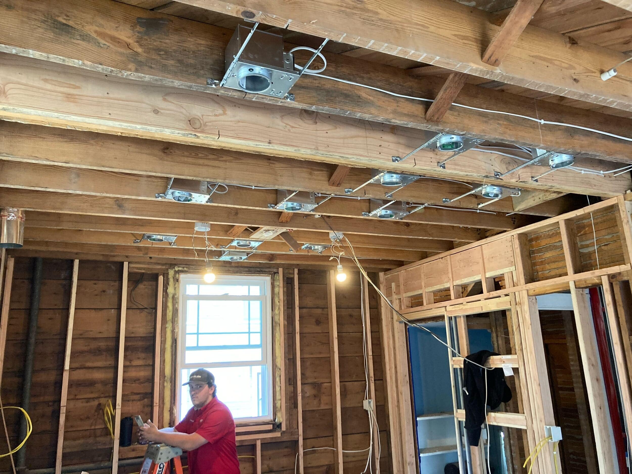 kitchen electrical changes in ceiling shown through exposed beams and new openings for can lights
