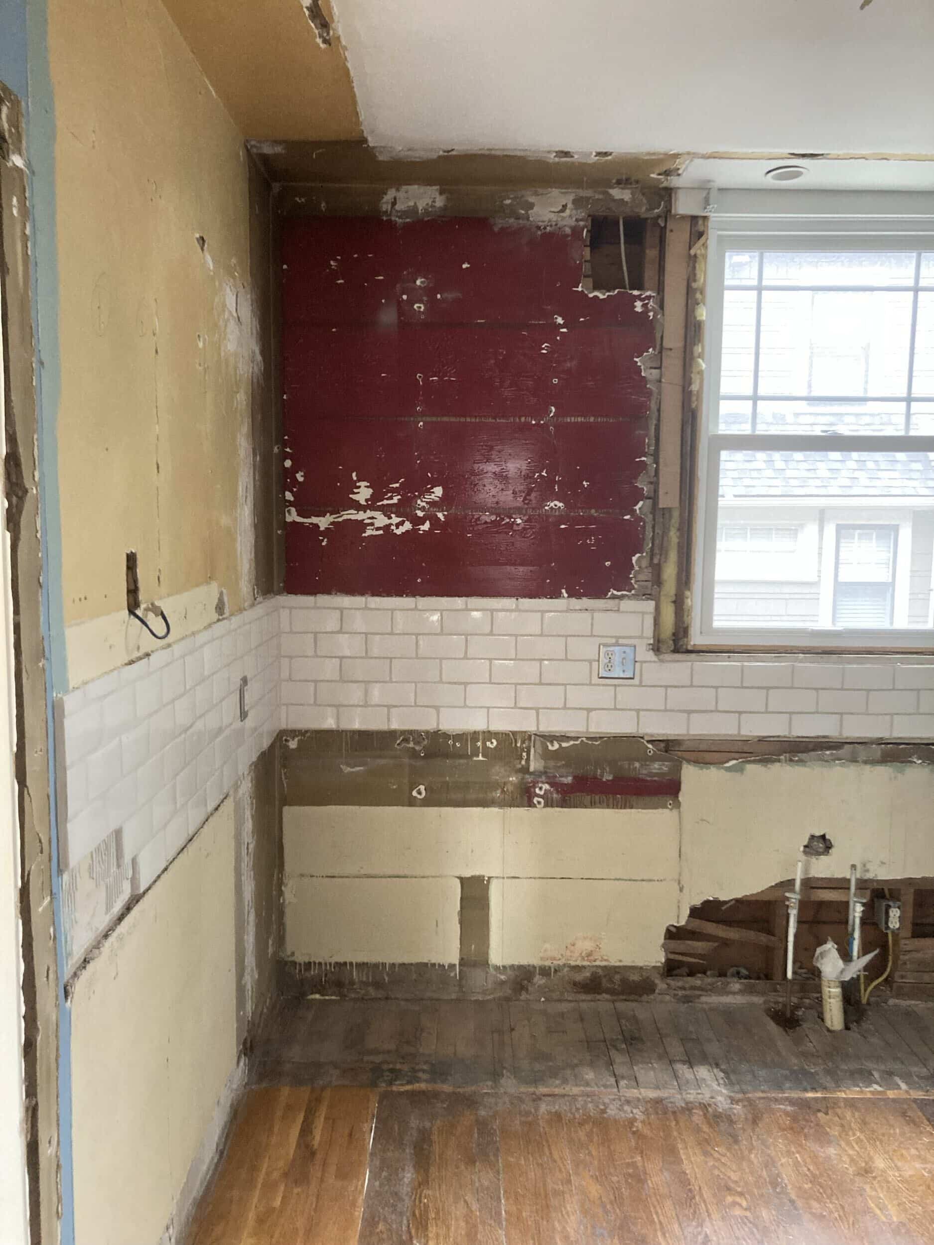 kitchen demo of cabinets and now walls are beat up and some backsplash remains that will be taken off soon