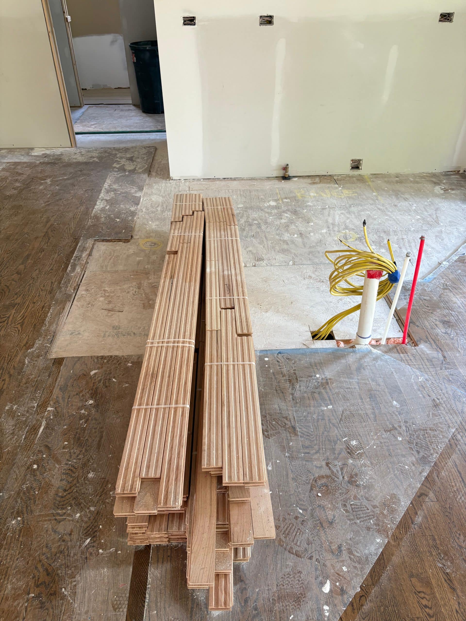 new hardwood floors delviered and piled up on floor in lenexa remodelin project 