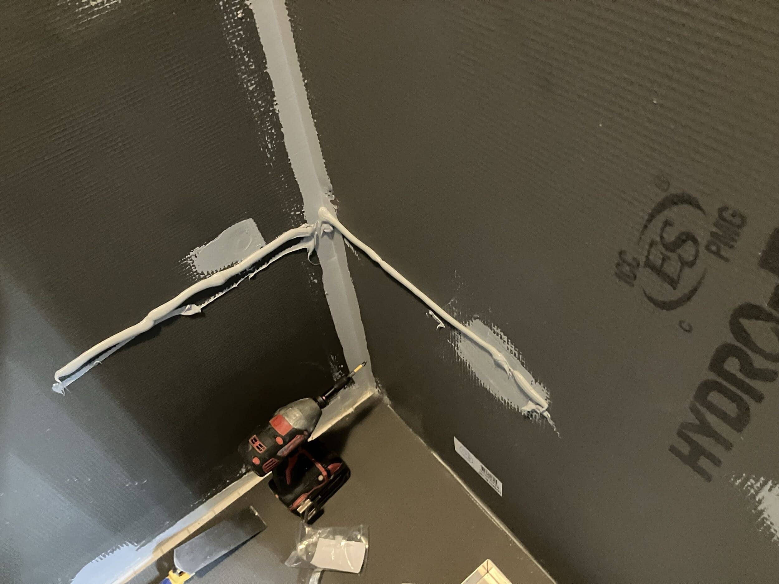 prepping to hang shelf in shower